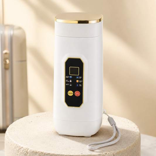 A white cylindrical electric kettle or hot water dispenser with a gold-trimmed top and a black control panel on the front, displayed on a round stone pedestal with a wrist strap.