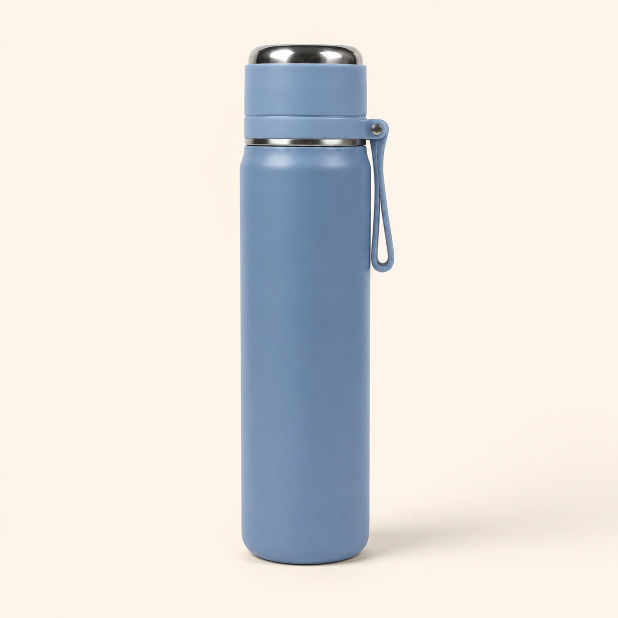 A matte blue insulated water bottle with a stainless steel lid and a matching blue carrying loop, shown on a light cream background.