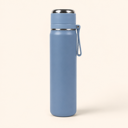A matte blue insulated water bottle with a stainless steel lid and a matching blue carrying loop, shown on a light cream background.