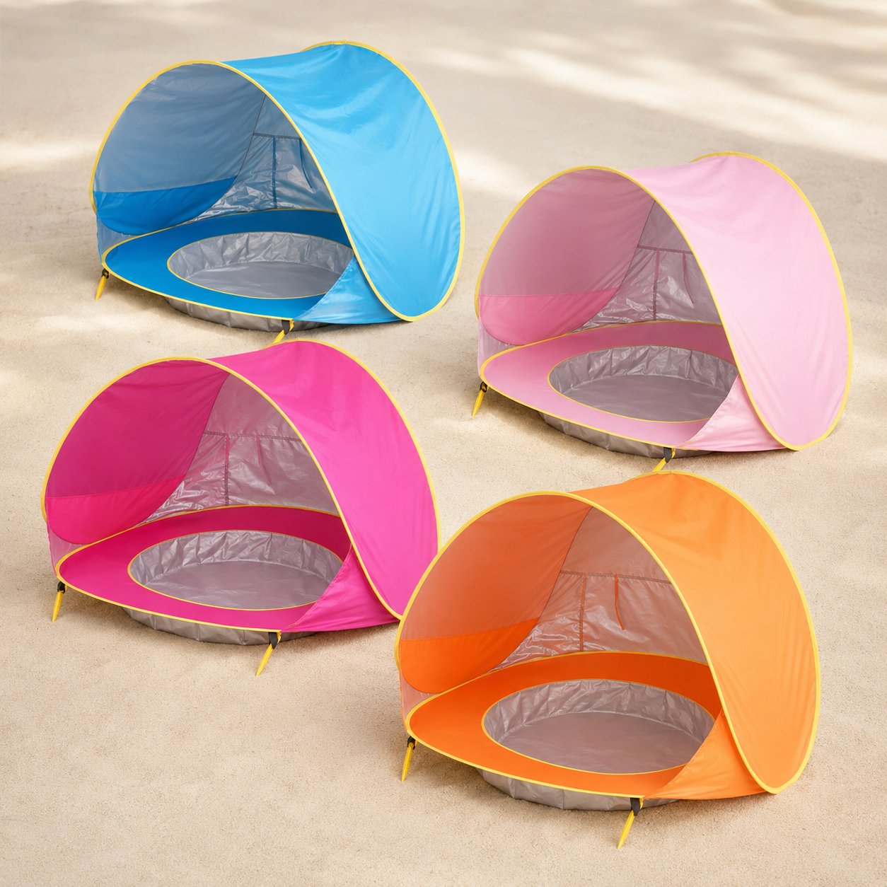 Four inflatable pop-up beach tents in blue, pink, magenta, and orange, arranged on a sandy ground.