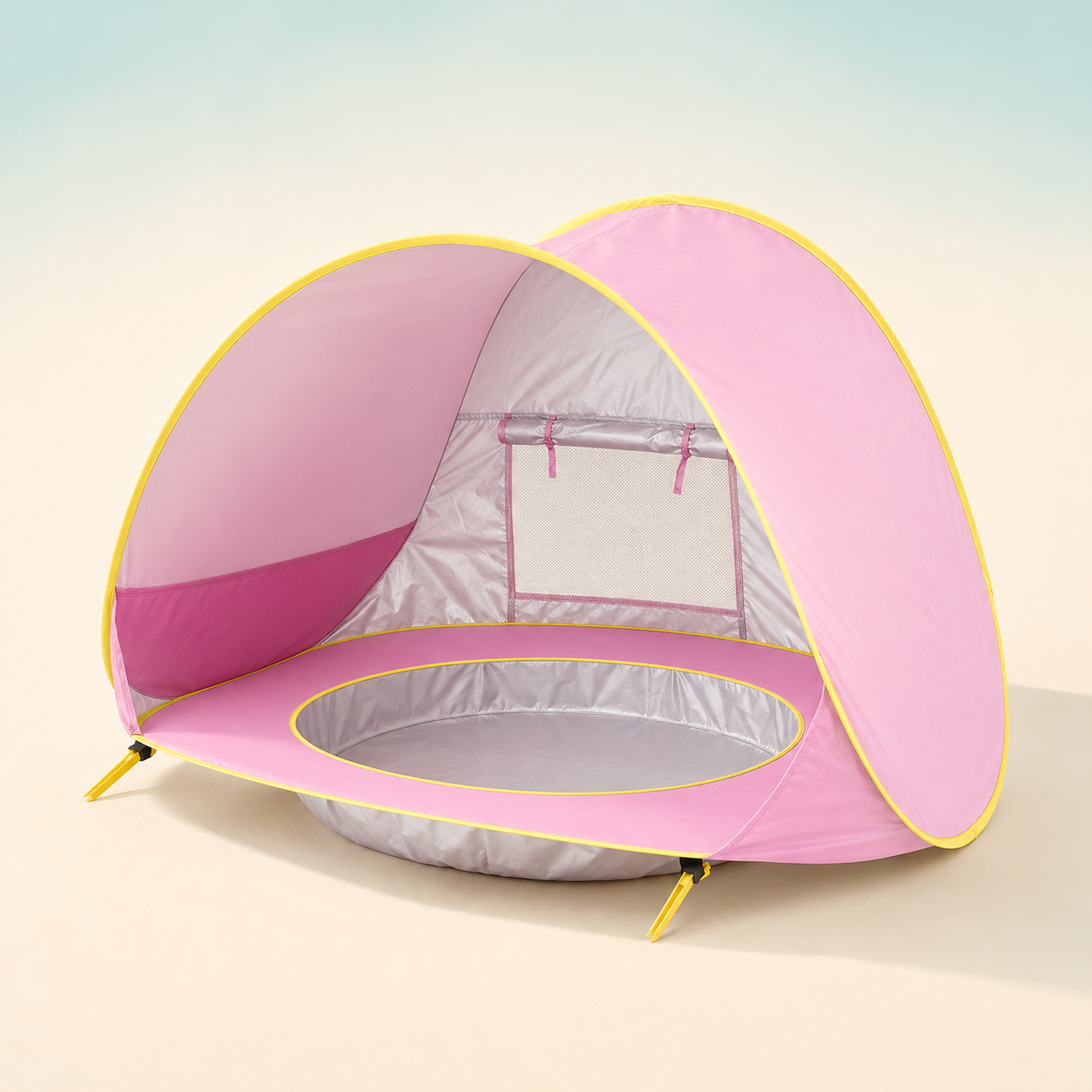 A pink pop-up baby tent with a silver interior and yellow trim, shown on a soft beige gradient background.