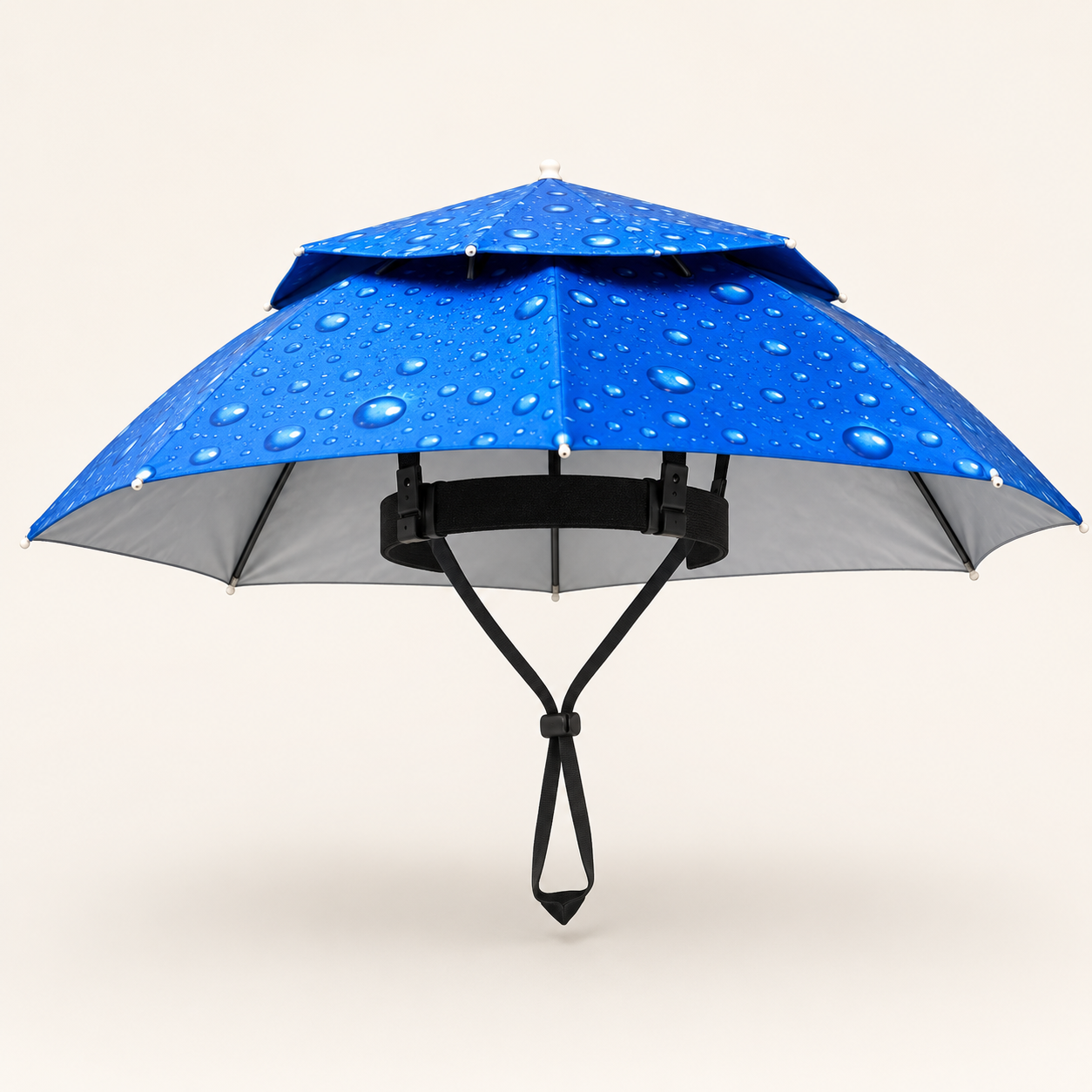 A blue double-layered umbrella with water droplets on the canopy, featuring a black handle and strap, set against a solid light beige background.