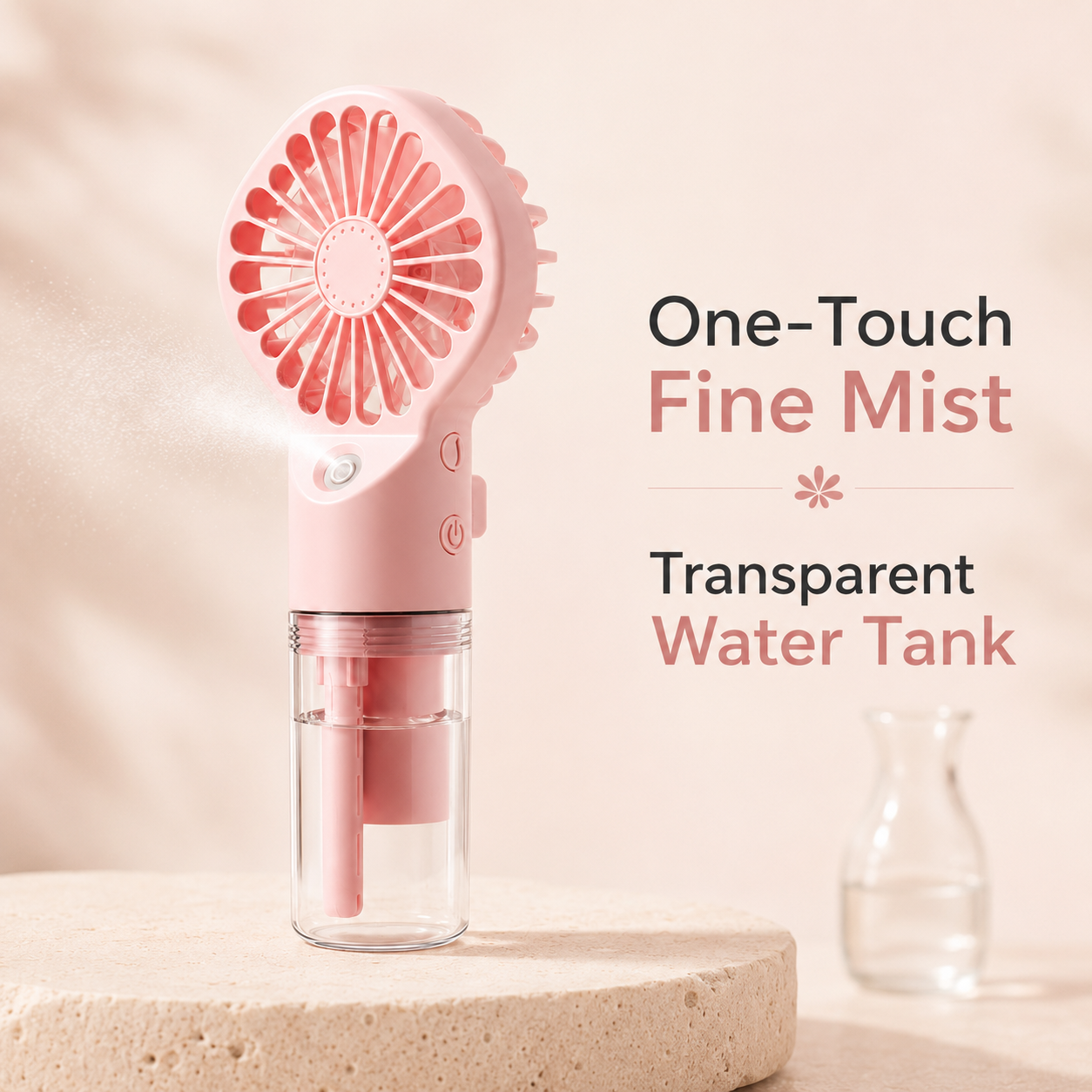 Pink handheld fan mist cleaner with a clear water tank, shown on a beige stone pedestal with text reading 'One-Touch Fine Mist' and 'Transparent Water Tank'.